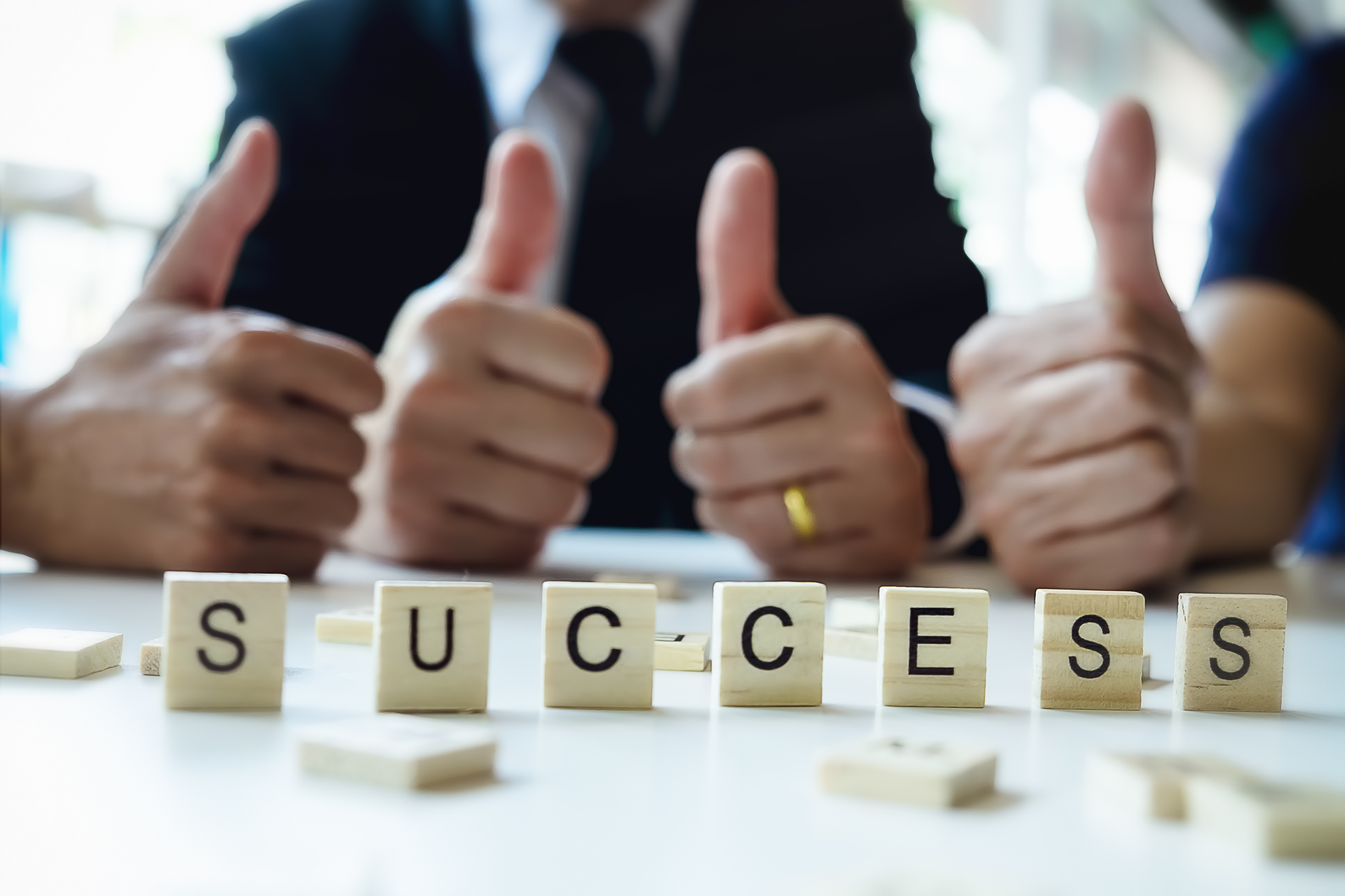 Success Word on Business Working Table. Wooden Cross Word